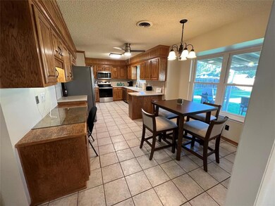 Dining room with sink, a textured ceiling, light t