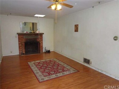 Living room offers skylight, fireplace and laminat