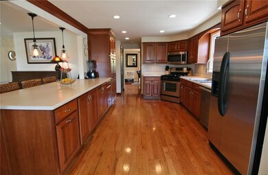 Plenty of cherry cabinetry and counter top space..