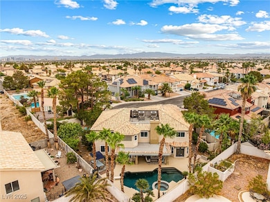 Aerial perspective of suburban area featuring a pool area and a mountain backdrop