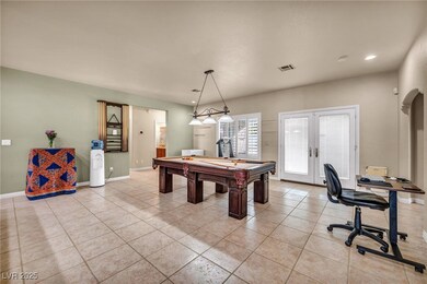 Recreation room with french doors, light tile patt