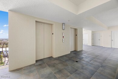 Unfurnished room with elevator, a textured wall, and a textured ceiling