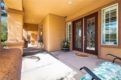 Doorway to property featuring stucco siding, cover