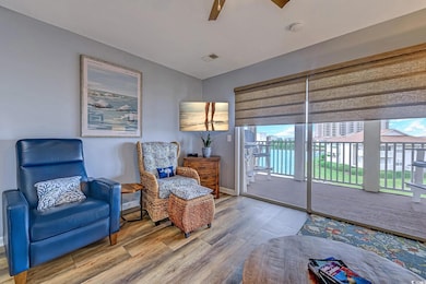 Sitting room featuring baseboards, visible vents, a wealth of natural light, and wood finished floors