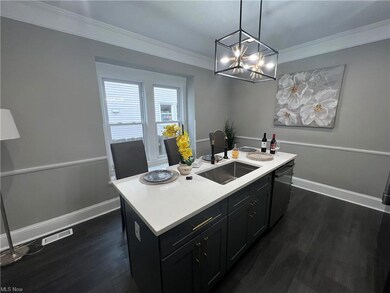 Bathroom featuring a notable chandelier, hardwood flooring, and crown molding
