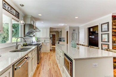 Kitchen features granite counters, gas oven/cook t