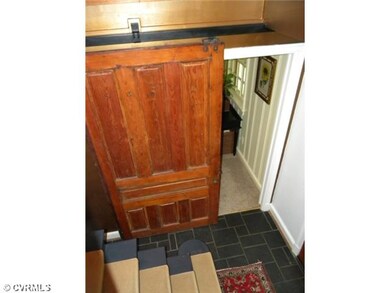Foyer - Reclaimed barn door on roller track on ent