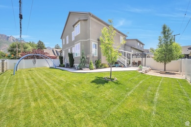 Back of property with stucco siding, a fenced backyard, and a patio