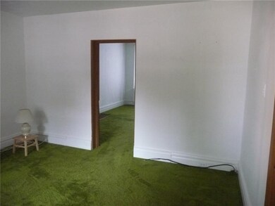 Front room has twin windows, an original fireplace