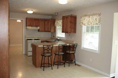 Kitchen with gas stove and window above sink