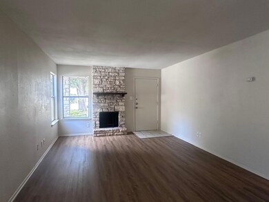 Unfurnished living room with dark wood-style floo