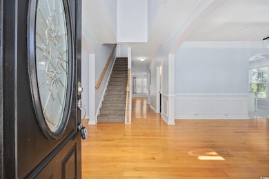 Entryway featuring arched walkways, light wood-sty