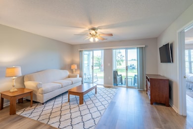 Living area featuring a textured ceiling, ceiling 