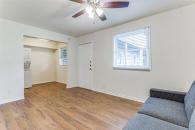 Living area featuring stacked washer and clothes 