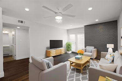 Living area featuring wood finished floors, a cei
