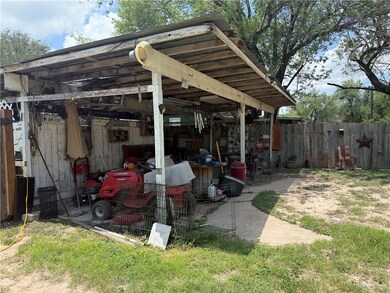 View of patio featuring a pole building and an outbuilding