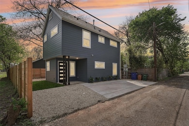 Back of property with fence and a shingled roof