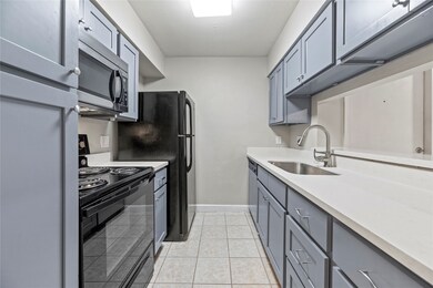 This galley kitchen offers elegant quartz counters