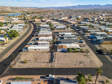 Aerial overview of property's location with a mountainous background and nearby suburban area