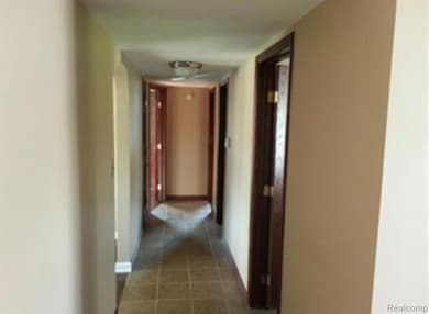 Corridor featuring tile patterned flooring