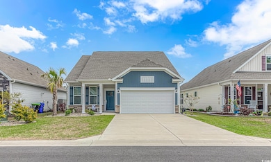 View of front facade with concrete driveway, stone