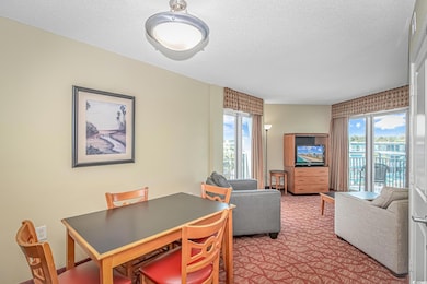 Dining room with carpet flooring and a textured ce