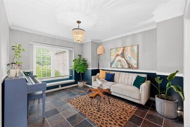 Dining room/office has crown, chair molding and tile flooring.