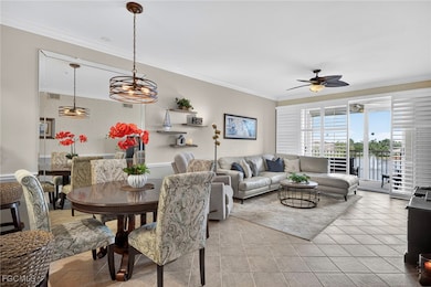 Dining area with ornamental molding, tile patterned floors, and ceiling fan