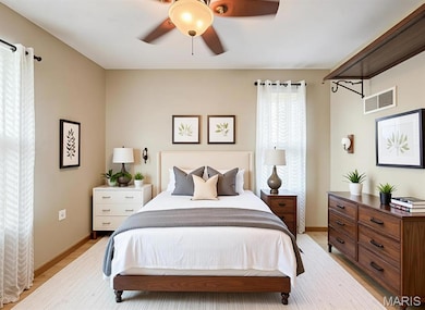 Digitally Staged Bedroom featuring a ceiling fan and light wood finished floors