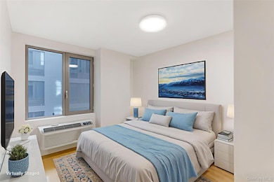 Bedroom featuring wood finished floors and a wall unit AC