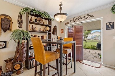 Tiled dining area featuring ornamental molding