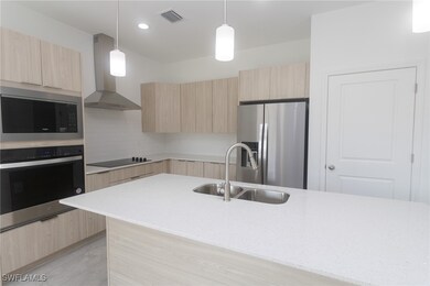 Kitchen featuring stainless steel appliances, ligh