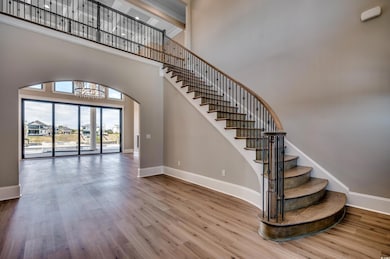 Stairway with a high ceiling, a notable chandelier