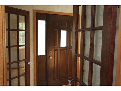 Original wood doors and french doors grace the ent