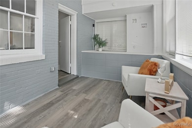 Sitting room featuring wood finished floors and br