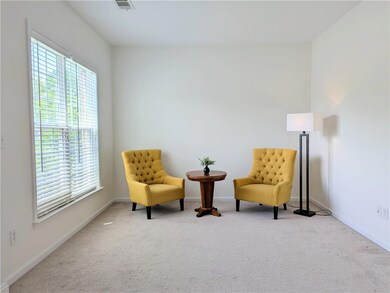 Sitting room featuring carpet flooring and baseboards
