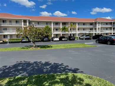 View of building exterior with covered parking