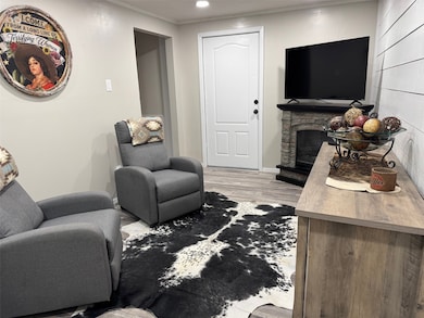 Living area featuring a fireplace, recessed lighting, and light wood-style floors