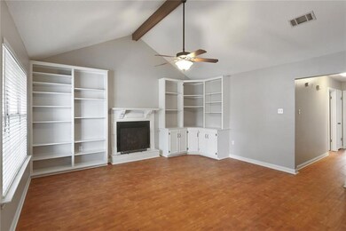 Living room with cathedral ceilings, built-ins, fi