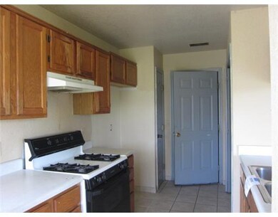 Kitchen. galley style kitchen with launrdy area at