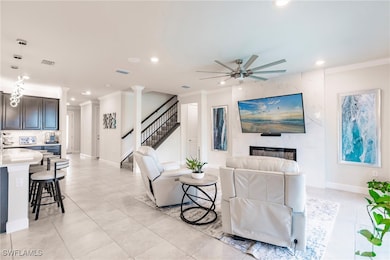 Living room featuring stairway, ornamental molding