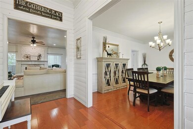 Dining room with ceiling fan with notable chandelier, crown molding, and dark hardwood / wood-style floors