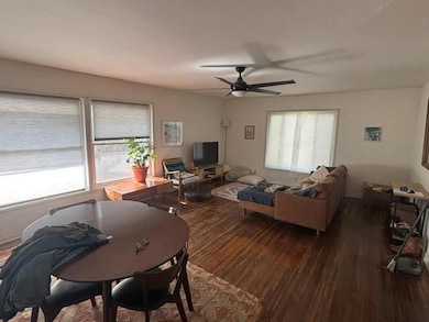 Living room with a ceiling fan and wood finished 