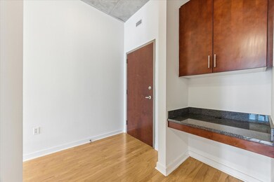 Kitchen featuring light wood-style floors, dark s