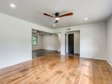 Recessed led lighting, trendy ceiling fans and original hardwood flooring create an exceptional space in the living room.  The room offers plenty of space for furniture layout options.