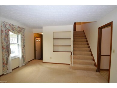 Foyer entry with closet, built-in shelving and sta
