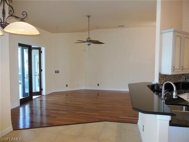 VIEW OF LIVING ROOM FROM KITCHEN BAR AND BREAKFAST