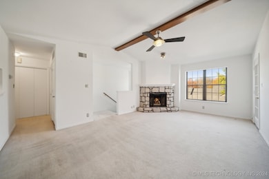 Beautiful vaulted ceiling with beam and fireplace.