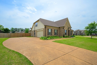 View of side of property with brick siding, driveway, and an attached garage