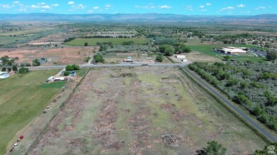 Aerial view of property's location with a mountain backdrop and rural landscape